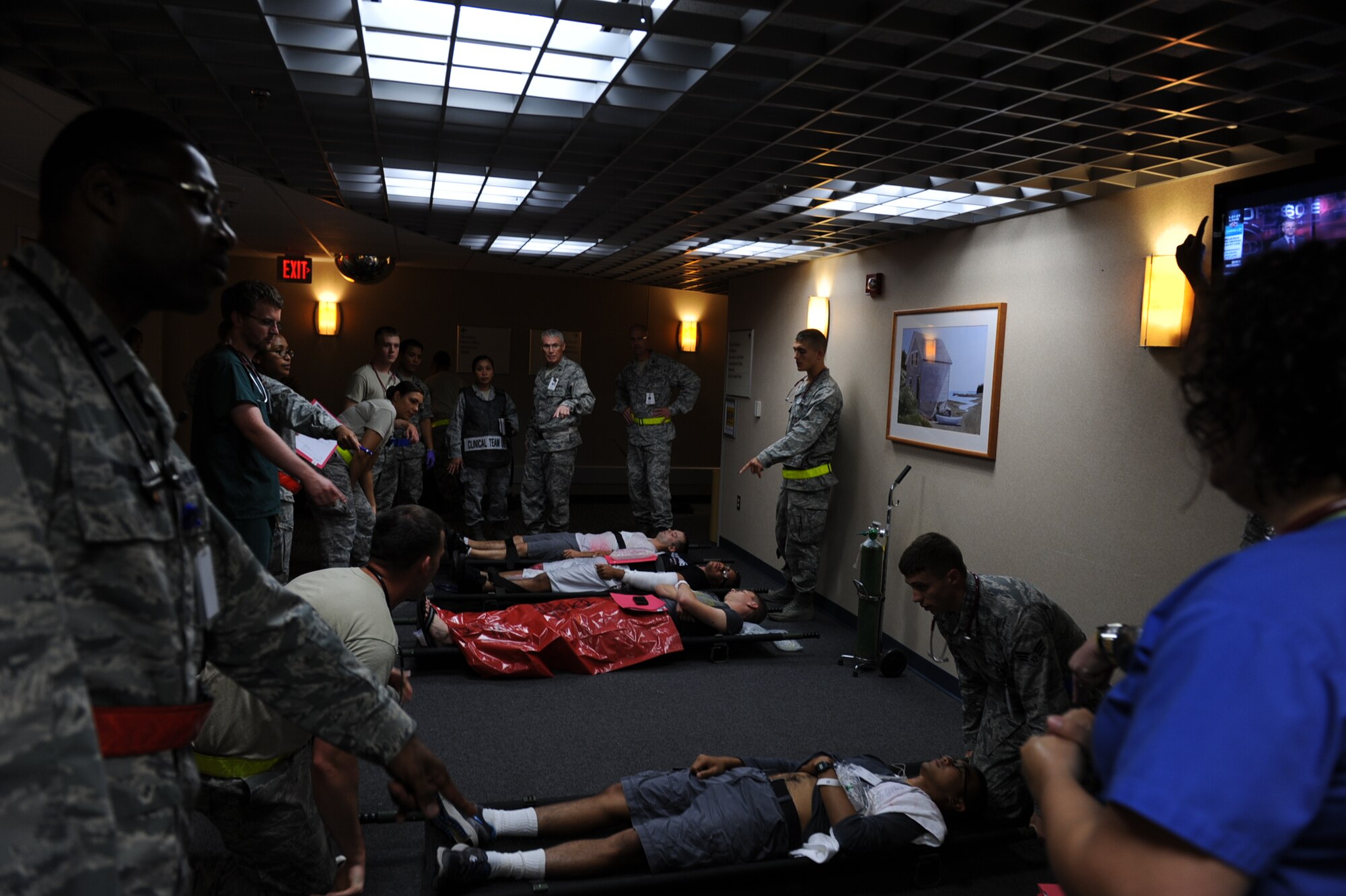A member of the 19th Medical Group asks which simulated patient is next to be transported to an ambulance during a Major Accident Response Exercise July 24, 2013, at Little Rock Air Force Base, Ark. The Medical Group played an instrumental role in the exercise treating and transporting simulated wounded around base. (U.S. Air Force photo by Airman 1st Class Cliffton Dolezal)