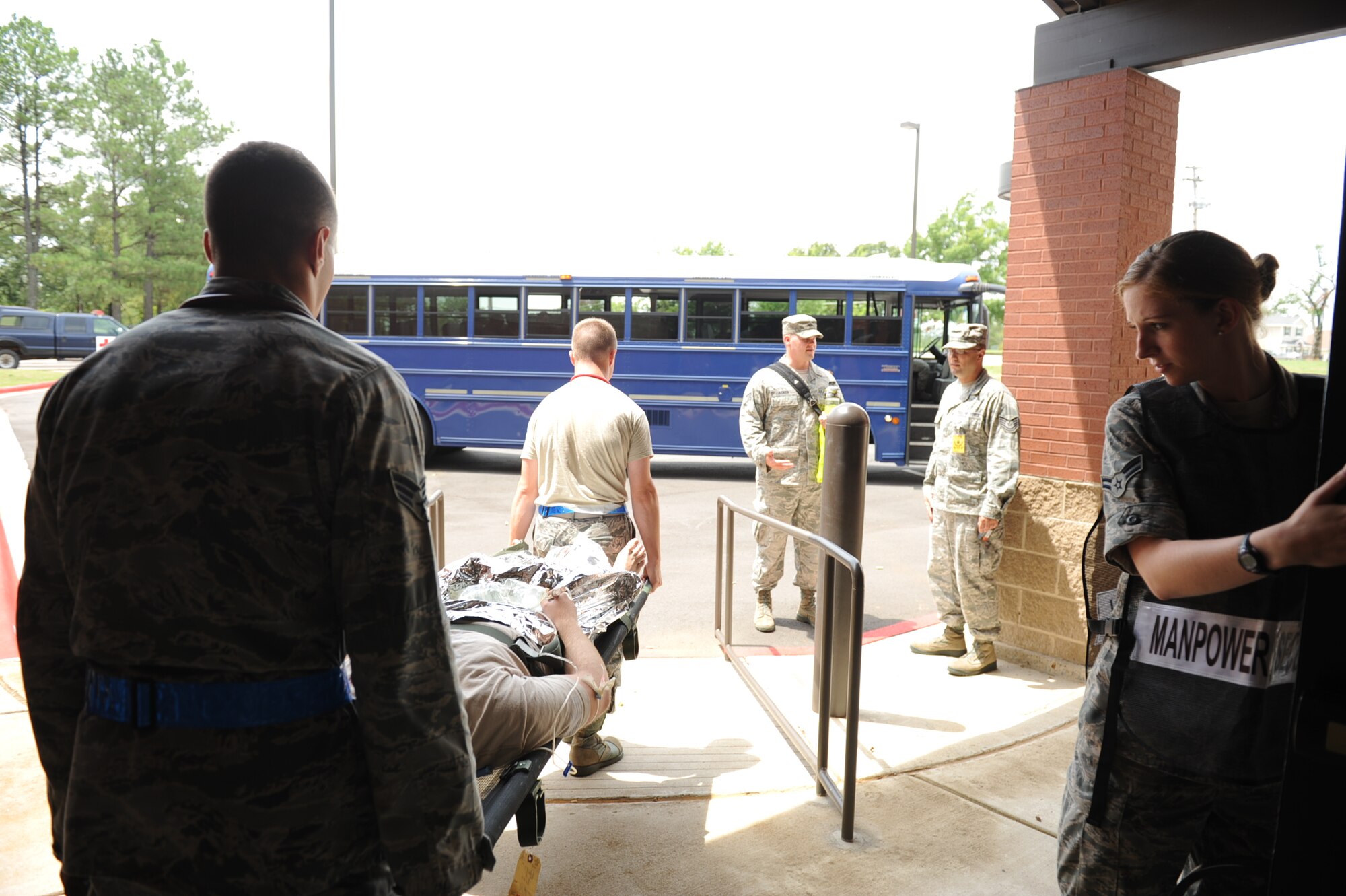 Members from the 19th Medical Group transport a simulated critically wounded person to an ambulance during a Major Accident Response Exercise July 24, 2013, at Little Rock Air Force Base, Ark. The purpose of the MARE was to test the response of the base’s response to an exercise scenario. (U.S. Air Force photo by Airman 1st Class Cliffton Dolezal)