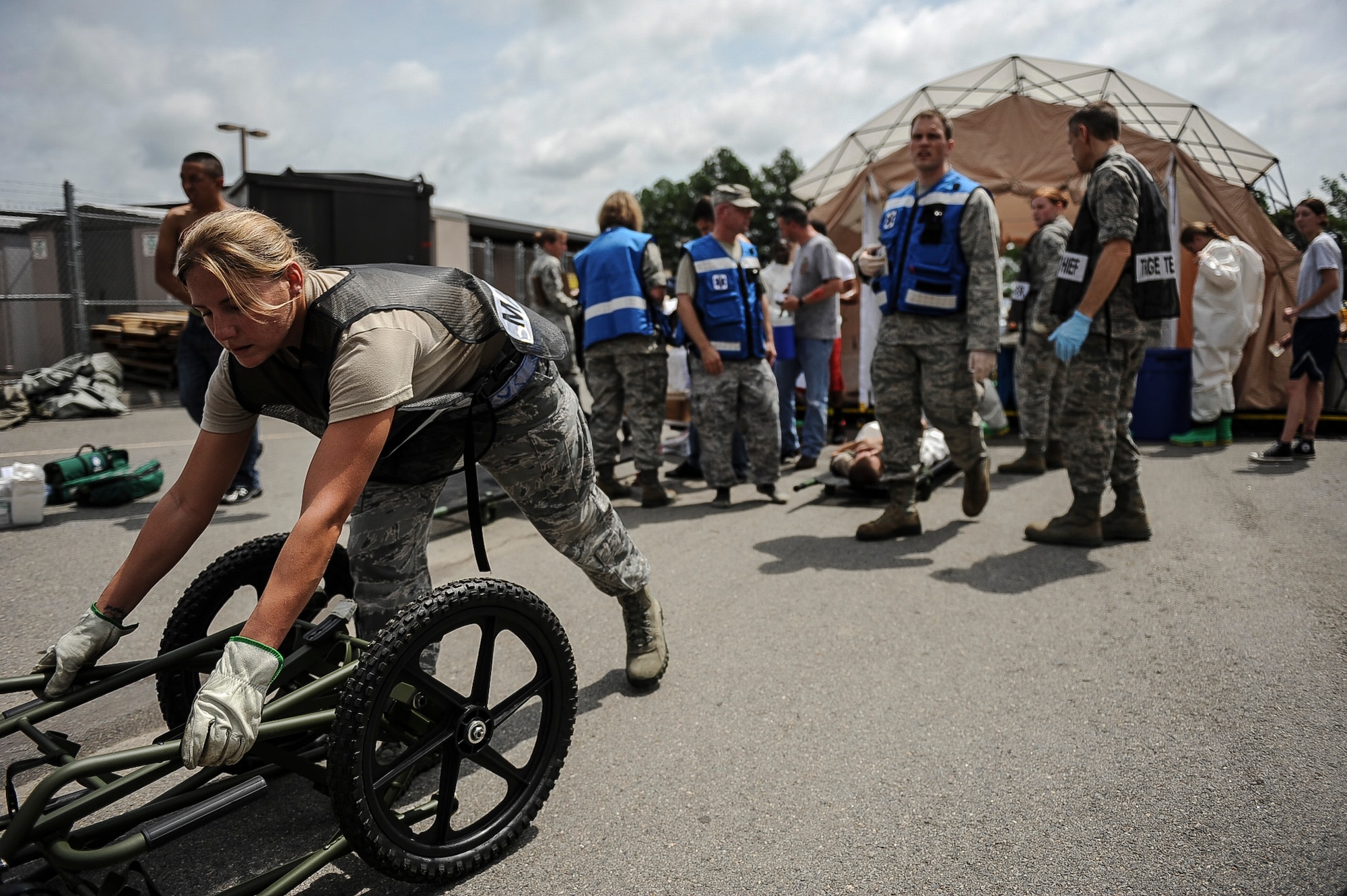 Staff Sgt. Shonna Wilkerson, a 19th Aerospace Medical Dentist Squadron dental technician, grabs a litter carrier to transport simulated wounded from decontamination tent to the medical group during a Major Accident Response Exercise July 24, 2013, at Little Rock Air Force Base, Ark. The purpose of the MARE was to test the response of the bases and the city of Jacksonville’s first responders. (U.S. Air Force photo by Airman 1st Class Cliffton Dolezal)