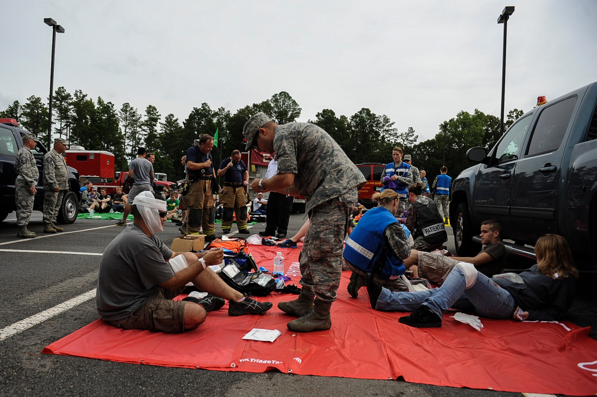 Medics from the 19th Medical Group, tend to simulated wounded during a Major Accident Response Exercise July 24, 2013, at Little Rock Air Force Base, Ark. The purpose of the MARE was to test the response of the bases and the city of Jacksonville’s first responders. (U.S. Air Force photo by Airman 1st Class Cliffton Dolezal)