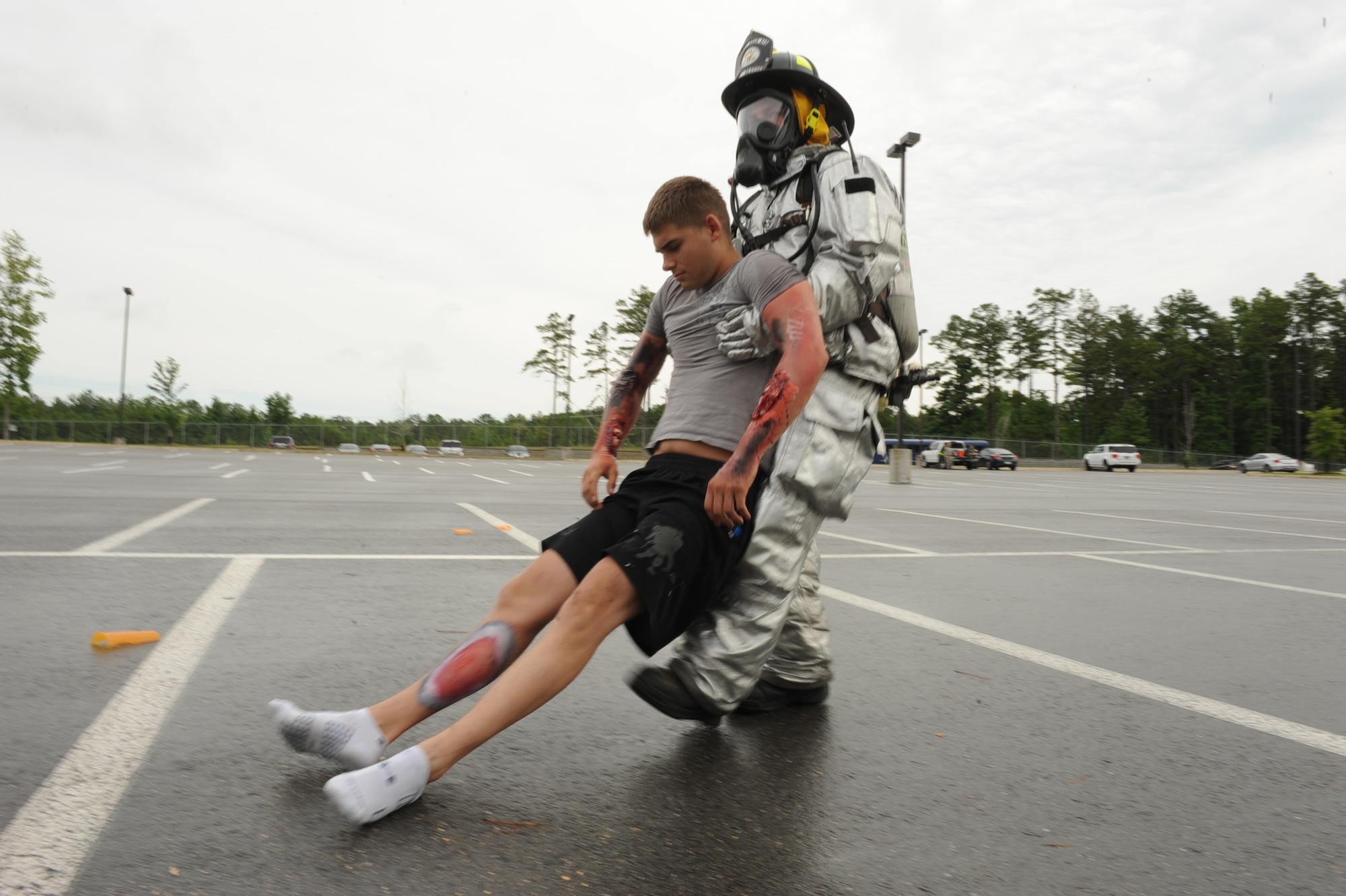 Airman 1st Class Tyler Coleman-Shaw, a 19th Civil Engineering Squadron firefighter, drags a simulated unconscious Airman 1st Class Steven Hamilton, a 19th Component Maintenance Squadron fuel systems repairer, to safety from a simulated disaster area during a Major Accident Response Exercise July 24, 2013, At Little Rock Ari Force Base, Ark. The purpose of the MARE was to evaluate the response of base personnel to the exercise scenario. (U.S. Air Force photo by Airman 1st Class Cliffton Dolezal)