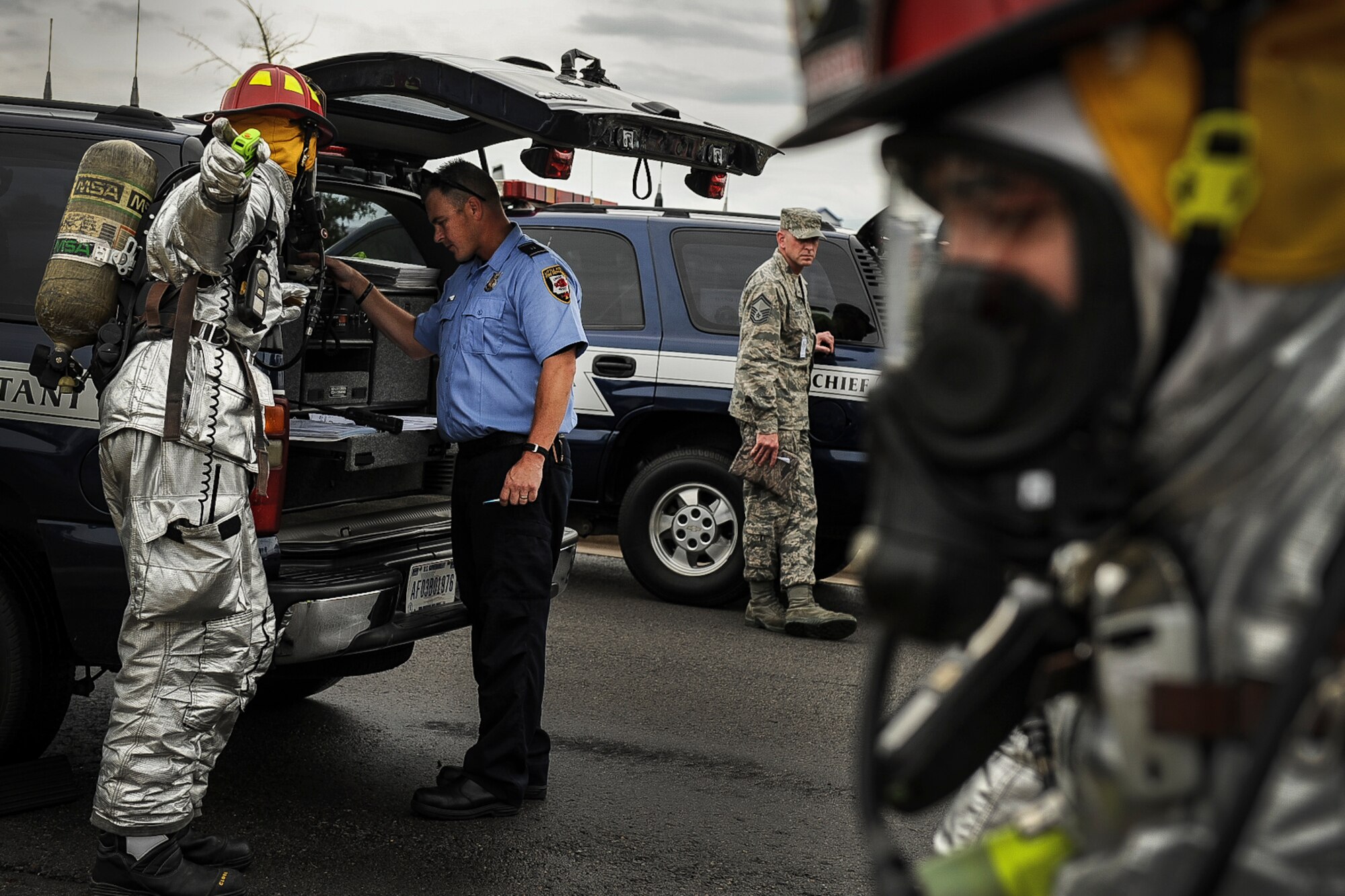 Firefighters from the 19th Civil Engineer Squadron assess the best way to approach the scene of a simulated explosion during a Major Accident Response Exercise July 24, 2013, at Little Rock Air Force Base, Ark. The MARE showcased the cooperation and partnership between base and Jacksonville emergency and medical personnel. (U.S. Air Force photo by Airman 1st Class Cliffton Dolezal)