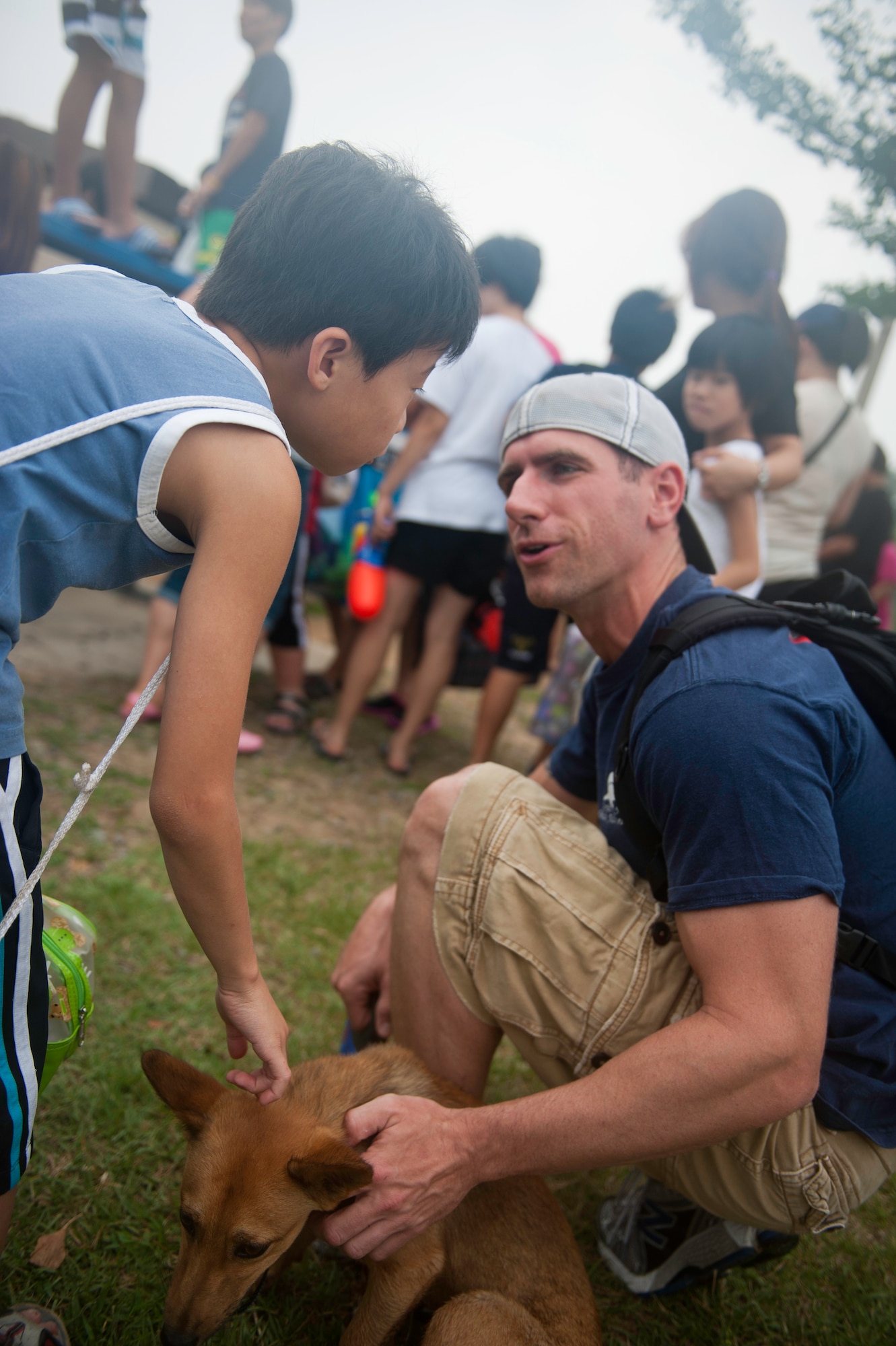 Master Sgt. Ryan Bobzin, 8th Civil Engineer Squadron, speaks with a child from the Ilmagwon Orphanage during Summer Fun Day, at Kunsan Air Base, Republic of Korea, July 27, 2013. The day’s events were organized by the Airmen Committed to Excellence Council and gave children from the orphanage a chance to have fun with members of the Wolf Pack. (U.S. Air Force photo by Senior Airman Clayton Lenhardt/Released)