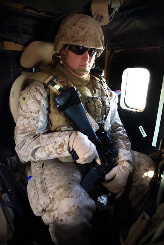 U.S. Marine Corps Lance Cpl. Jacob Johnson sits in the back of a mine-resistant, ambush-protected vehicle during a combat logistics patrol in Helmand province, Afghanistan, July 25, 2013. Johnson, a heavy equipment operator, is assigned to Transportation Support Company, Combat Logistics Regiment 2, Regional Command, Southwest.