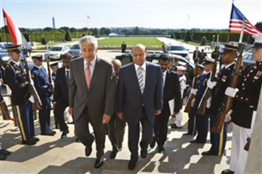 U.S. Defense Secretary Chuck Hagel, left, hosts an honor cordon to welcome Yemen's President Abdo Rabby Mansour Hadi to the Pentagon, July 30, 2013. The two leaders met to discuss bilateral defense topics. 