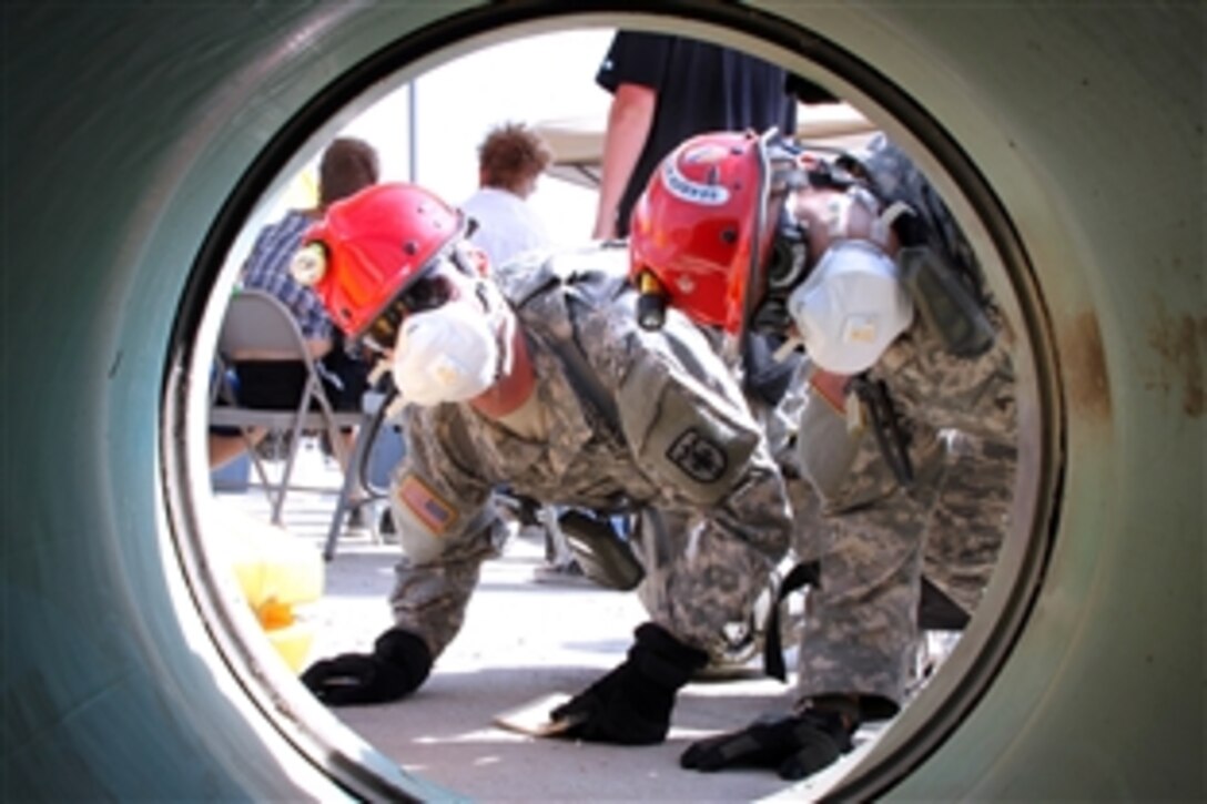 Army Sgt. Manuel Lechuga, right, and Army Pvt. Nick Knappe, left, search a rubble pile for mock victims during a natural disaster training scenario as part of exercise Vigilant Guard 2013 in Northglenn, Colo., July 24, 2013. Lechuga and Knappe are assigned to the Colorado National Guard's Chemical, Biological, Radiological, Nuclear - Enhanced Response Force Package.