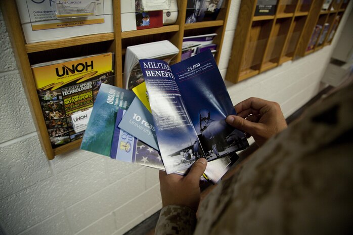 A Marine reads college pamphlets at the Education Center aboard Marine Corps Base Camp Lejeune, July 30. Service members can receive up to $4,500 for tuitions assistance.