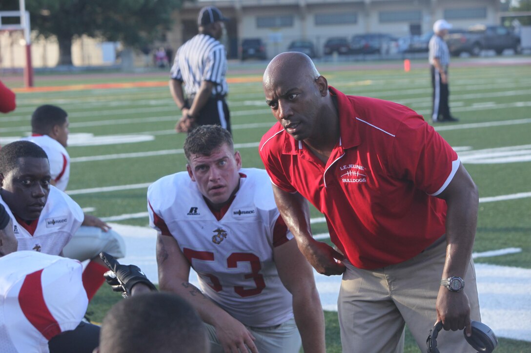 The Lejeune Bulldogs’ defensive coordinator gives his defensive lineman advice on how to break through the Tri-County Crusaders’ offensive line during their game at Liversedge Field aboard Marine Corps Base Camp Lejeune, July 27. The Bulldogs forced several turnovers during the game, which led to their victory.