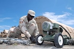 Air National Guard Staff Sgt. Robert Thomas, an engineer with the 474th Prime Base Engineer Emergency Force, repairs a hole in the diaphragm of a pump at Joint Task Force Guantanamo's Camp Justice, Sept. 19, 2008. Air Guard civil engineer squadrons manned by hundreds of construction and repair experts will involuntary deploy overseas in historic numbers and scope during the next 24 months.