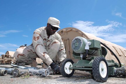 Air National Guard Staff Sgt. Robert Thomas, an engineer with the 474th Prime Base Engineer Emergency Force, repairs a hole in the diaphragm of a pump at Joint Task Force Guantanamo's Camp Justice, Sept. 19, 2008. Air Guard civil engineer squadrons manned by hundreds of construction and repair experts will involuntary deploy overseas in historic numbers and scope during the next 24 months.