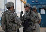 Capt. Phil Benner, assistant brigade engineer for 56th Stryker Brigade Combat Team, 28th Infantry Division, Multi-National Division - Baghdad, points out to a Soldier about what needs to be done to make a pump operational at the Khark Water Treatment Plant south of Tarmiyah. The plant services much of the greater Baghdad areas.
