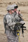 (left to right) Army Sgt. Allen Abbott and Army Staff Sgt. Joseph McMurtrey, 28th Forward Agri-business Development Team, use a compass and measuring tape to accurately measure and mark a local farmer's field for the future planting of a vineyard, Feb. 28.