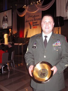 Army Staff Sgt. Matthew, a decorated army medic who served a tour in Iraq with the Rhode Island Army National Guard, poses with an award he accepted at the 3rd annual Armed Services YMCA 'Angels of Battlefield' gala in Washington, D.C., on March 11, 2009.