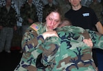 Army Capt. Shannon Machmiller (left), a civil affairs officer with the 196th Maneuver Enhancement Brigade in Sioux Falls, S.D., grapples with her opponent, during training for the Modern Army Combatives Program held at the 196th Regiment, Regional Training Institute on March 12, at Fort Meade, S.D.