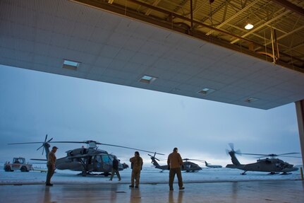 Soldiers from the Alaska Army National Guard's 1st 207 Aviation Regiment guide a Black Hawk onto the flight line in Bethel, Alaska, March 12, 2009. The 1st 207 Aviation Regiment is responsible for transporting all medical teams and supplies during Operation Arctic Care, a Navy-led readiness exercise providing no-cost health care to 14 villages in Western Alaska's Yukon-Kuskokwim region.