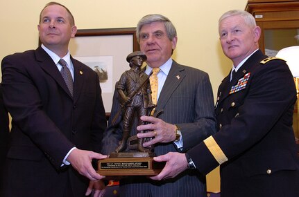 Brig. Gen. Timothy J. Kadavy, the adjutant general of Nebraska (left) and Lt. Gen. Clyde A. Vaughn, director of the Army National Guard (right) present the Gen. G. V. "Sonny" Montgomery Award to Sen. Ben Nelson of Nebraska March 23 at the Hart Senate Office Building in Washington, D.C. The Montgomery Award, a bronze minuteman statuette, is the top honor of the Chief of the National Guard Bureau, Gen. Craig R. McKinley.