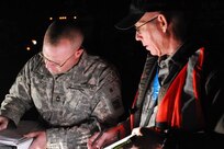 Sgt. 1st Class Elwin Farnsworth from Hotel Company, 1-161st Infantry (Combined Arms Battalion), 81st Brigade Combat Team, Washington Army National Guard, discusses the route to Scania with Lead KBR controller Dennis Bos minutes before departure.