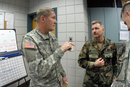 Army Col. Jim Hrdlicka, commander, Joint Task Force-East, and his deputy, Air Force Col. Ron Solberg, discuss efforts to corral the Red River in the face of potentially historic water levels during a meeting at the task force's operations center at the Armed Forces reserve Center in Fargo, N.D..