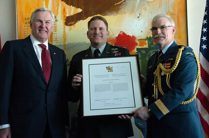 U.S. Army Col. Steve R. Williams (center) receives a framed citation and the Canadian Meritorious Service Medal from Canadian ambassador Michael Wilson (left) and Canadian Maj. Gen. Douglas Langton, commander Canadian Defense Liaison Staff, Washington, March 24 at the Canadian Embassy in Washington.