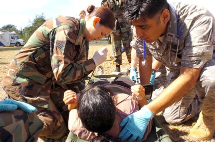 Senior Airman Kara Nicholas, a medic with the 161st Air Refueling Wing, Arizona National Guard, and 2nd Lt. Tomas Chavez, a flight surgeon candidate with the same, check the vital signs of an incoming patient during Exercise Vigilant Guard, Wednesday, March 25, 2009, in Camp Santiago, Puerto Rico. Vigilant Guard is an exercise that tests disaster readiness, and the 161st's response with the Expeditionary Medical Support system, a full-service deployable field hospital.