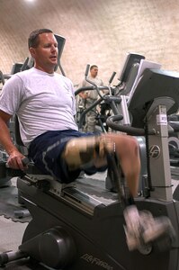 Major Alan Brown rides a stationary bicycle March 21 at Bagram Airfield, Afghanistan. Major Brown is an amputee C-130 Hercules pilot deployed with the 774th Expeditionary Airlift Squadron from the 187th Airlift Squadron of the Wyoming Air National Guard. He lost his leg in a hunting accident 10 years ago, and after seven years he regained his qualifcations to fly. Major Brown works out daily riding the stationary bike using a custom strap developed by the unit's life support crew.