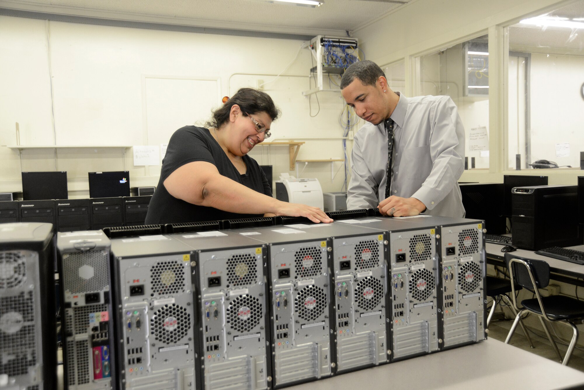 Bryan People (right), 412th Communications Squadron, shows Emilia Henry, Desert High School Regional Occupational Program instructor, computers donated to Desert High School through the Computers for Learning program, which People oversaw for the past 15 months. (U.S. Air Force photo by Rebecca Amber) 