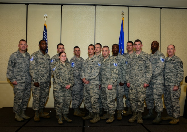 Members of Joint Base Charleston gather for a group photo with Col. Richard McComb, JB Charleston commander, and Chief Master Sgt. Al Hannon, 628th Air Base Wing command chief, after a promotion ceremony July 30, 2013, at JB Charleston – Air Base, S.C. Twenty-Five members of JB Charleston were recently promoted. (U.S. Air Force photo/Senior Airman Dennis Sloan)