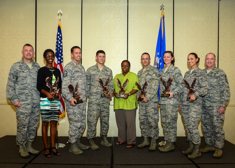 (Left)Col. Richard McComb, Joint Base Charleston commander, and (Right) Chief Master Sgt. Al Hannon, 628th Air Base Wing command chief, stand with the 628th Air Base Wing 2nd Quarter Award Winners during the monthly Promotion/Quarterly Awards ceremony July 30, 2013, at Joint Base Charleston – Air Base, S.C. (Left to Right), Jennifer Green, Civilian of the Quarter Category II, Master Sgt. Eric Cicogna, Senior Noncommissioned Officer of the Quarter, Senior Airman Kelby Rosengarten, Airman of the Quarter, Joyce Martin, Civilian of the Quarter Category I, Tech. Sgt. Darren Perry, Noncommissioned Officer of the Quarter, Airman 1st Class Kathryn Raethel, Honor Guard Member of the Quarter and Airman Jennie Short, Volunteer of the Quarter. Award Winners not pictured include 1st Lt. Htein Lin, Junior Company Grade Officer and Capt. Jonathan Blount, Senior Company Grade Officer. (U.S. Air Force photo/ Senior Airman Dennis Sloan)