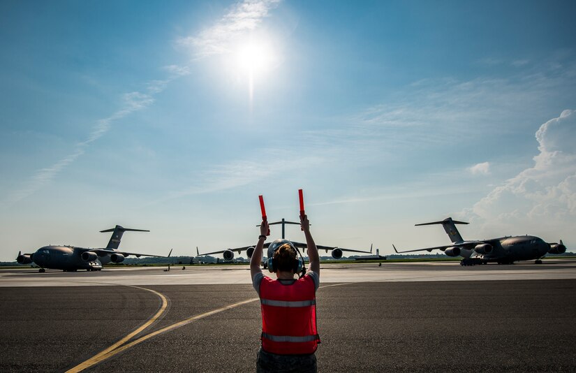 Senior Airman Brandi Barentine, 437th Aircraft Maintenance Squadron crew chief, marshals a C-17 Globemaster III July, 30, 2013, at Joint Base Charleston – Air Base, S.C. (U.S. Air Force photo/ Senior Airman Dennis Sloan)