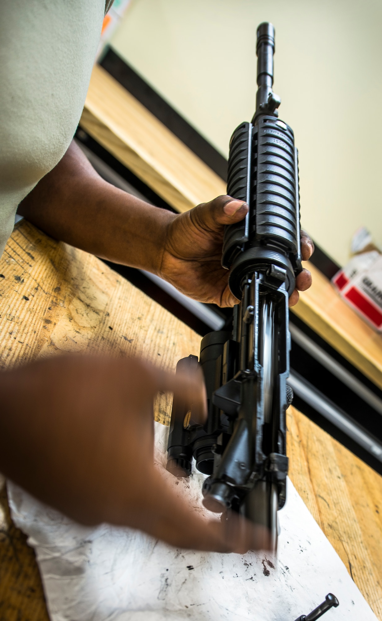 Staff Sgt. Julius Taylor, 628th Security Forces Squadron Combat Arms Training and Maintenance instructor, inserts the bolt carrier into the upper receiver of an M-4 carbine rifle July 30, 2013, at Joint Base Charleston – Air Base, S.C. CATM instructors are subject matter experts on operating, disassembling and maintaining all weapons held in the armory. (U.S. Air Force photo/ Senior Airman Dennis Sloan)