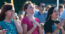 Excited fans of country singer Scotty McCreery watch as he performs his first USO show at Minot Air Force Base, N.D., July 24. McCreery performed the free concert for Minot Airmen and their families during his visit to the base. (U.S. Air Force photo/Airman 1st Class Apryl Hall)