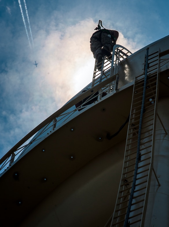 Senior Airman Michael Ang, 628th Civil Engineer Squadron water fuels system maintenance craftsman, climbs a water tower to perform a chlorine test July 29, at Joint Base Charleston – Air Base, S.C. The water tower is used in emergencies such as destruction from hurricanes or heavy storms. The water’s chlorine level was safe for human consumption. (U.S. Air Force photo/ Senior Airman Dennis Sloan)