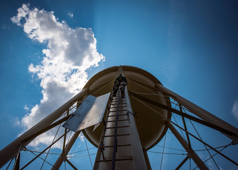 Senior Airman Michael Ang, 628th Civil Engineer Squadron water fuels system maintenance craftsman, climbs a water tower to perform a chlorine test July 29, 2013,at Joint Base Charleston – Air Base, S.C. The water tower is used in emergencies such as destruction from hurricanes or heavy storms. The water’s chlorine level was safe for human consumption. (U.S. Air Force photo/ Senior Airman Dennis Sloan)