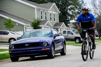 Staff Sgt. William Barrios, 628th Security Forces Squadron patrolman, rides a bicycle through a residential area, July 30, 2013, at Joint Base Charleston – Air Base, S.C. In close quarters on base, bicycle patrolmen can maneuver and respond more quickly than an automobile. This competency, in certain circumstances, allows patrolmen to respond to the installation's distress calls in a prompt and safe manner. (U.S. Air Force photo/Staff Sgt. Rasheen Douglas)