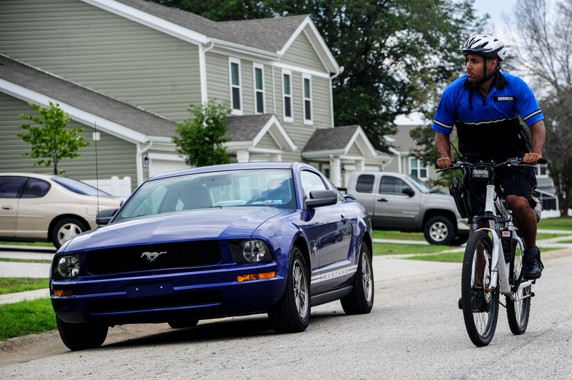 Staff Sgt. William Barrios, 628th Security Forces Squadron patrolman, rides a bicycle through a residential area, July 30, 2013, at Joint Base Charleston – Air Base, S.C. In close quarters on base, bicycle patrolmen can maneuver and respond more quickly than an automobile. This competency, in certain circumstances, allows patrolmen to respond to the installation's distress calls in a prompt and safe manner. (U.S. Air Force photo/Staff Sgt. Rasheen Douglas)