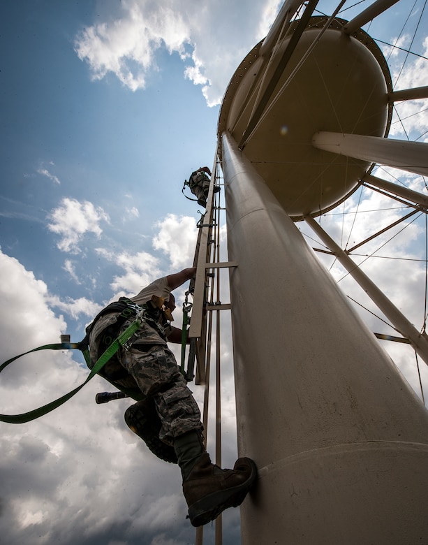 (Top) Staff Sgt. David Ertwine, and Senior Airman Michael Ang, 628th Civil Engineer Squadron water fuels system maintenance craftsmen, climb a water tower to perform a chlorine test July 29, 2013, at Joint Base Charleston – Air Base, S.C. The water tower is used in emergencies such as destruction from hurricanes or heavy storms. The water’s chlorine level was safe for human consumption. (U.S. Air Force photo/ Senior Airman Dennis Sloan)