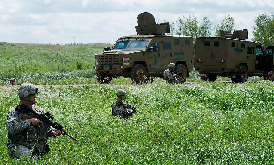 The Convoy Response Force personnel assigned to the 91st Security Forces Group recently participated in numerous required exercises to validate tactics, techniques, and procedures in the event of real world incidents. This particular exercise consisted of a Mission Category 1 movement to a missile site. While en route, a mock improvised explosive device was detonated disabling the command element’s vehicle, creating an impassable road separating the rear response elements from the resource vehicle. CRF personnel swiftly assaulted, recaptured and secured the resource from enemy personnel. (U.S. Air Force photo/Airman 1st Class Kristoffer Kaubisch)