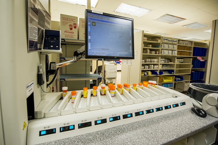 The ScriptPro Compact Robotic System automatic prescription speeds the time it takes to fill and refill prescriptions at  the Naval Health Clinic Charleston pharmacy, July 29, 2013, at Joint Base Charleston - Weapons Station, Goose Creek, S.C. The system automates the repetitive, manual tasks most subject to human error and can fill, label and deliver up to 150 prescriptions per hour. NHCC provides quality healthcare services for approximately 12,000 beneficiaries throughout the LowCountry, including a sick call clinic for Sailors assigned to the Weapons Station. (U.S. Air Force photo/ Senior Airman George Goslin)