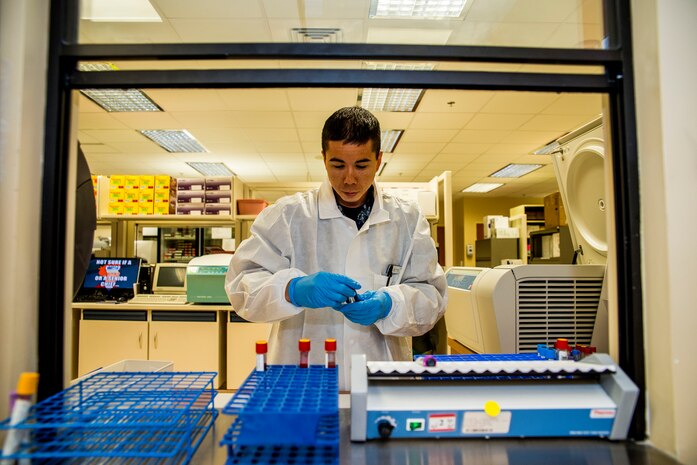 Petty Officer 3rd Class John Betts, Naval Health Clinic Charleston hospital corpsman, removes vials from a centrifuge in the NHCC  lab, July 29, 2013, at Joint Base Charleston - Weapons Station, Goose Creek, S.C. NHCC provides quality healthcare services for approximately 12,000 beneficiaries throughout the LowCountry, including a sick call clinic for Sailors assigned to the Weapons Station. (U.S. Air Force photo/ Senior Airman George Goslin)