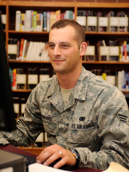 Senior Airman Derek Interrante, 28th Logistics Readiness Squadron aircraft parts store technician, takes advantage of one of the available computers and the scanner at the 28th Force Support Squadron Holbrook Library to create a travel voucher on Ellsworth Air Force Base, S.D., July 30, 2013. Materials and services offered at the library include online reading resources, a summer reading program, inter-library loans and the upcoming installation of personal-use computers. (U.S. Air Force photo by Airman 1st Class Ashley J. Thum/Released)