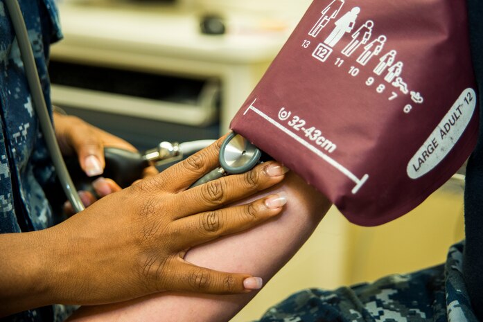 Seaman Yolanda King, Naval Health Clinic Charleston hospital corpsman, takes a patient’s  blood pressure July 29, 2013, at Joint Base Charleston - Weapons Station, Goose Creek, S.C. King was recently named NHCC’s Blue Jacket of the Quarter which is awarded to a junior Sailor for his or her outstanding performance during a three month period. NHCC provides quality healthcare services for approximately 12,000 beneficiaries throughout the LowCountry, including a sick call clinic for Sailors assigned to the Weapons Station. (U.S. Air Force photo/ Senior Airman George Goslin)