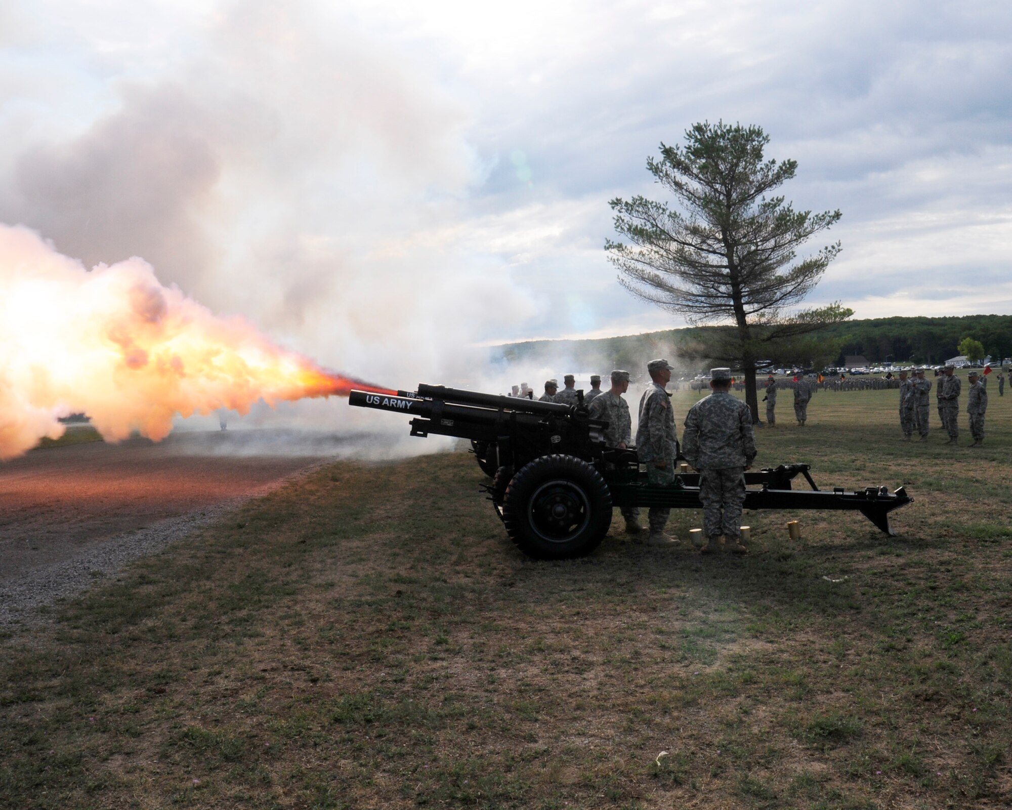 U.S. Army from the 1st Battery-119th Field Artillery Regiment fire a 21- gun salute in honor of Michigan Gov. Rick Snyder’s arrival at Camp Grayling, Camp Grayling, Mich., July 19, 2013. The salute was the commencement for the pass in review ceremony for Camp Grayling’s 100 year anniversary. (Air National Guard photo by Tech. Sgt. David Eichaker/released)