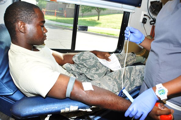 Staff Sgt. Edward Miller, 513th Maintenance Squadron, watches as phlebotomist Bryana Martin from the Oklahoma Blood Institute prepares his arm. Miller was one of approximately 30 reservists donating blood during the July UTA weekend. (U.S. Air Force Photo/Lt. Col. Kim Howerton)