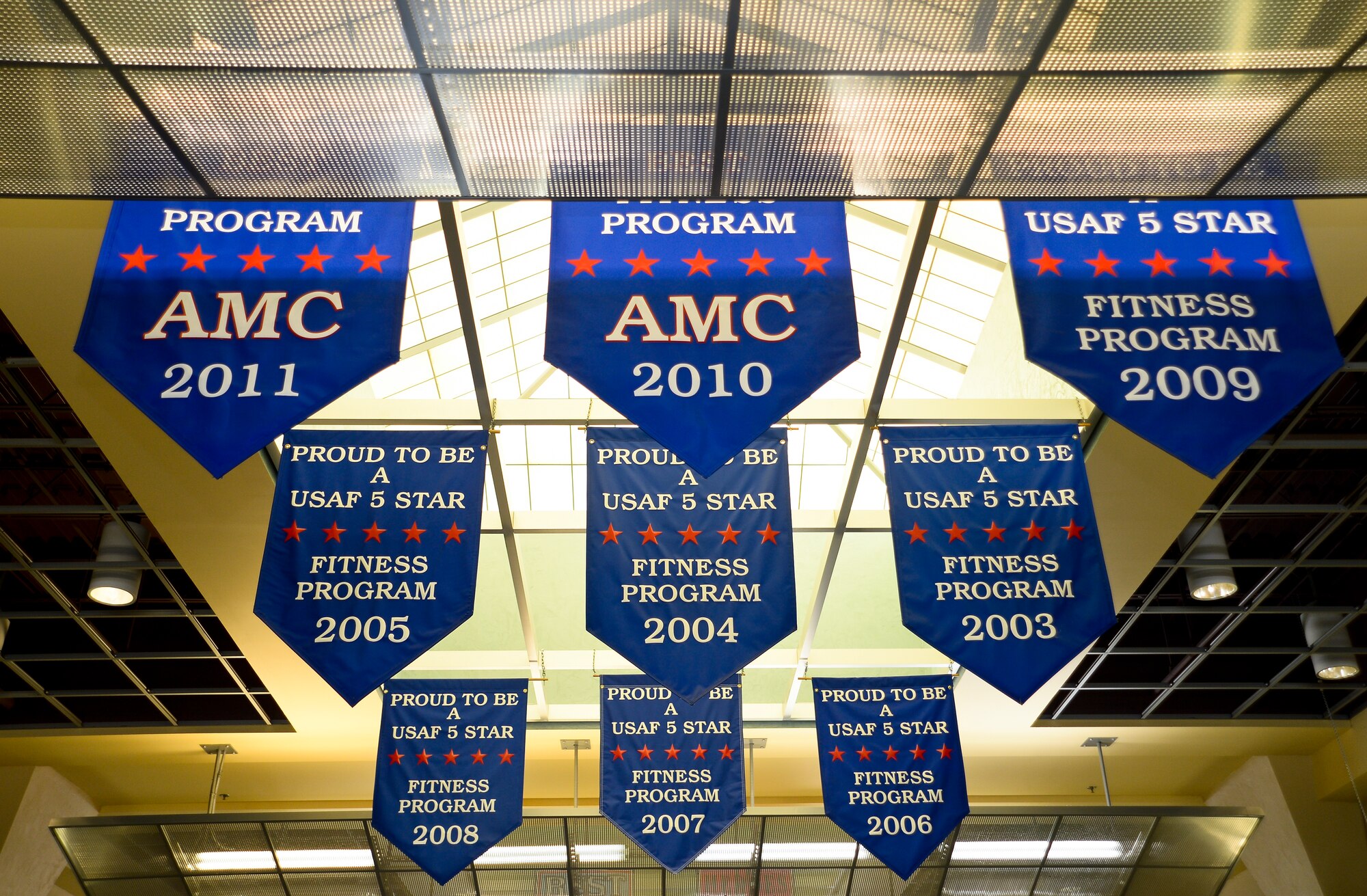 Nine five star award banners hang on the ceiling of the Short Fitness Center at MacDill Air Force, Fla., July 29, 2013. The fitness center has won seven, five star Air Force awards and three, five star Air Mobility Command awards recognizing their commitment to excellence, outstanding customer service and superior programs. (U.S. Air Force photo by Senior Airman Melissa Paradise/Released)