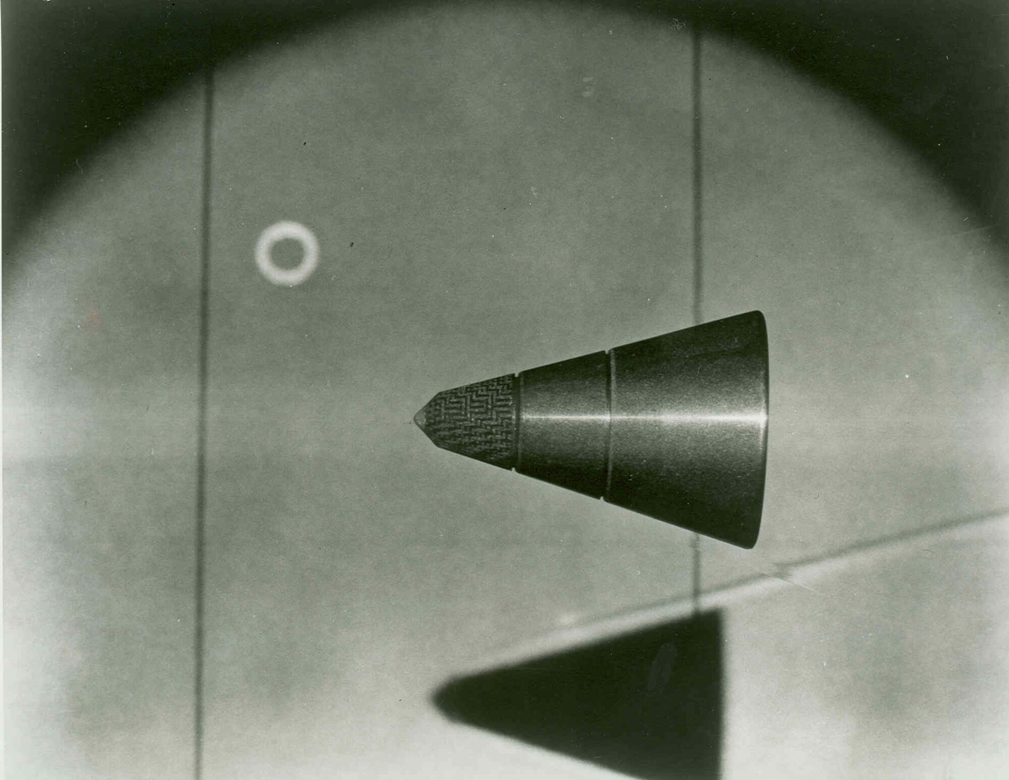 LASER-ILLUMINTAED PHOTOGRAPHY was developed at the Arnold Engineering Development Complex to study ablative effects on a 12,000 mph free-flight projectile in the Center’s 1,000-foot hypervelocity ballistic range. The technique provided a photographic exposure equivalent to 20 billionths of a second. (1970 AEDC Photo)