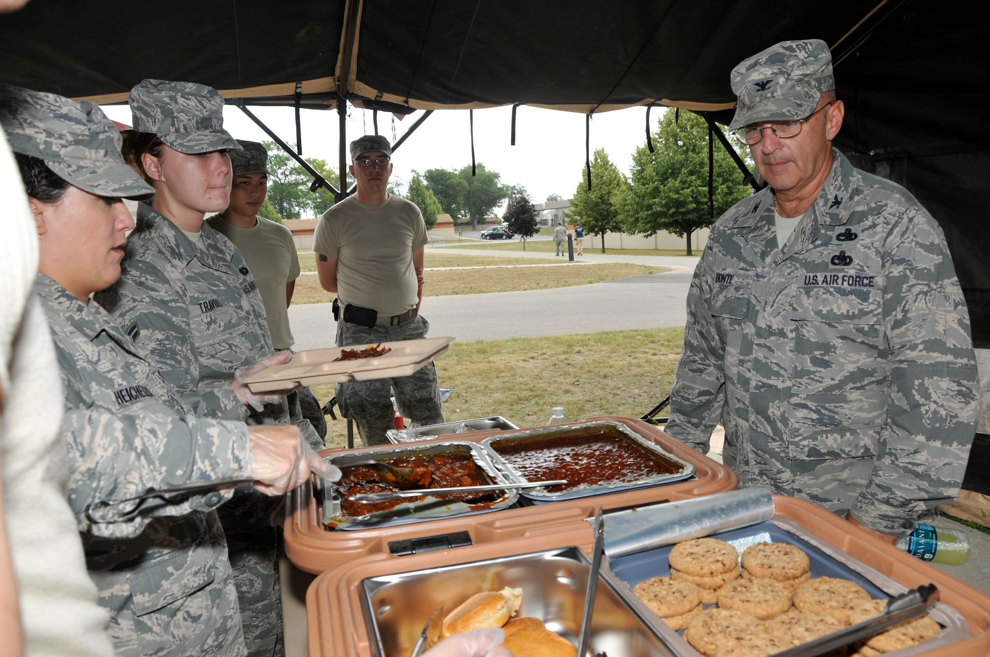 U.S. Air Force 181st Intelligence Wing Commander Col. Donald Bonte, the Indiana Air National Guard is served a lunch meal from the Single Pallet Expeditionary Kitchen (SPEK) setup July 18, 2013, at the Combat Readiness Training Center, Alpena, Mich. (U.S. Air National Guard photo by Senior Master Sgt. John S. Chapman/Released)