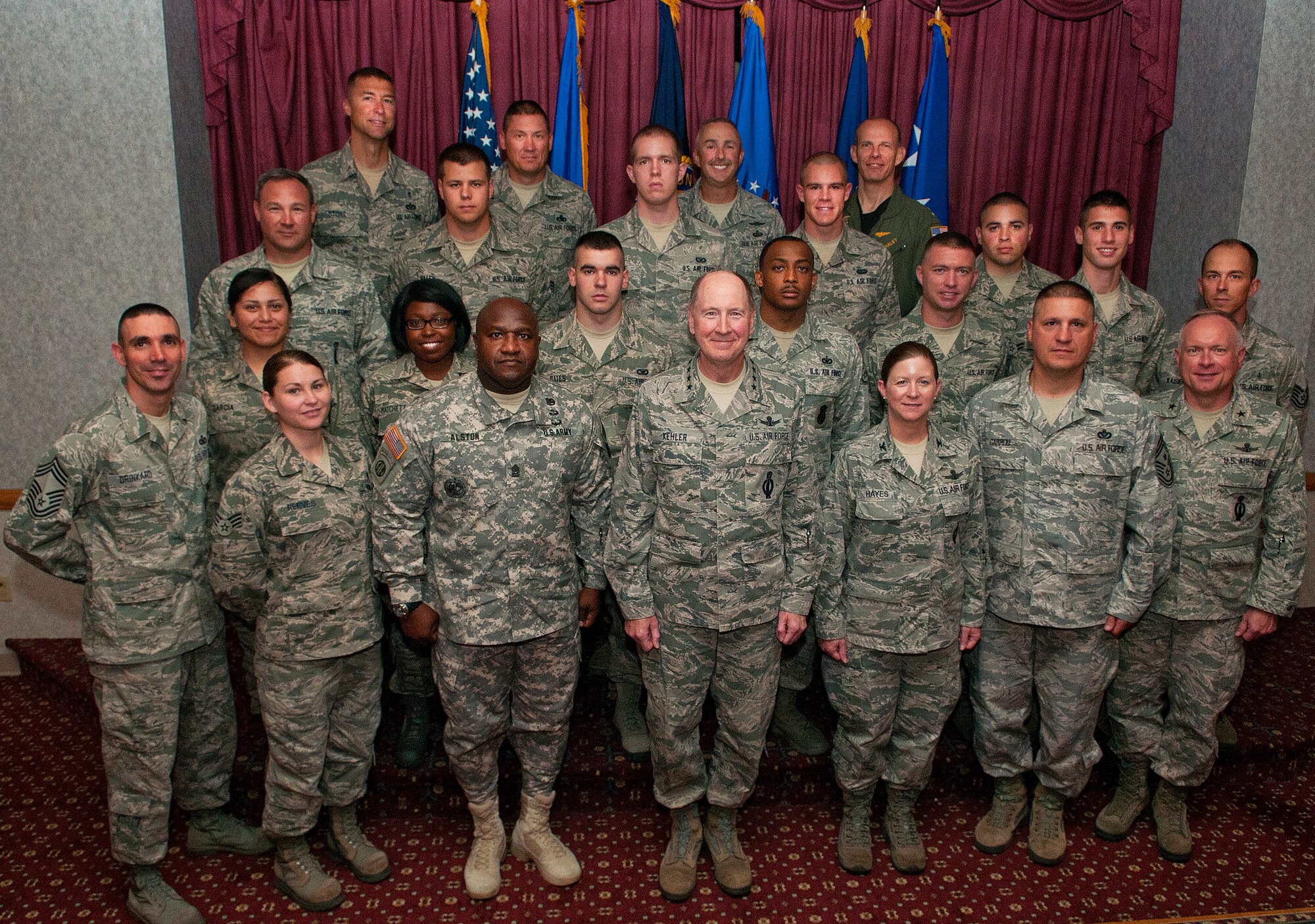 Gen. C. Robert Kehler, U.S. Strategic Command commander, center, poses along with Col. Tracey Hayes, 90th Missile Wing commander, and Army Command Sgt. Maj. Pat Alston, USSTRATCOM, with 90th MW Airmen who were designated “unsung heroes” following a luncheon at the Trail’s End Club, F.E. Warren Air Force Base, Wyo., July 30, 2013.  During lunch, Kehler asked the Airmen about their concerns and addressed the issues they raised. (U.S. Air Force photo by R.J. Oriez) 