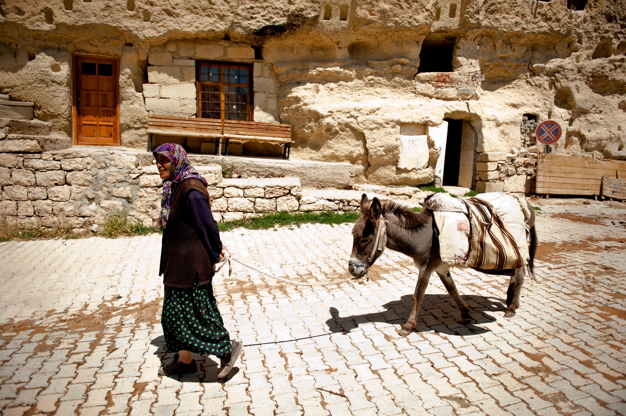 A Turkish woman walks her donkey down the street June 31, 2013, Karaman province, Turkey. The trip to Karaman province is one of several trips offered by the Outdoor Recreation Center. (U.S. Air Force photo by Senior Airman Daniel Phelps/Released)