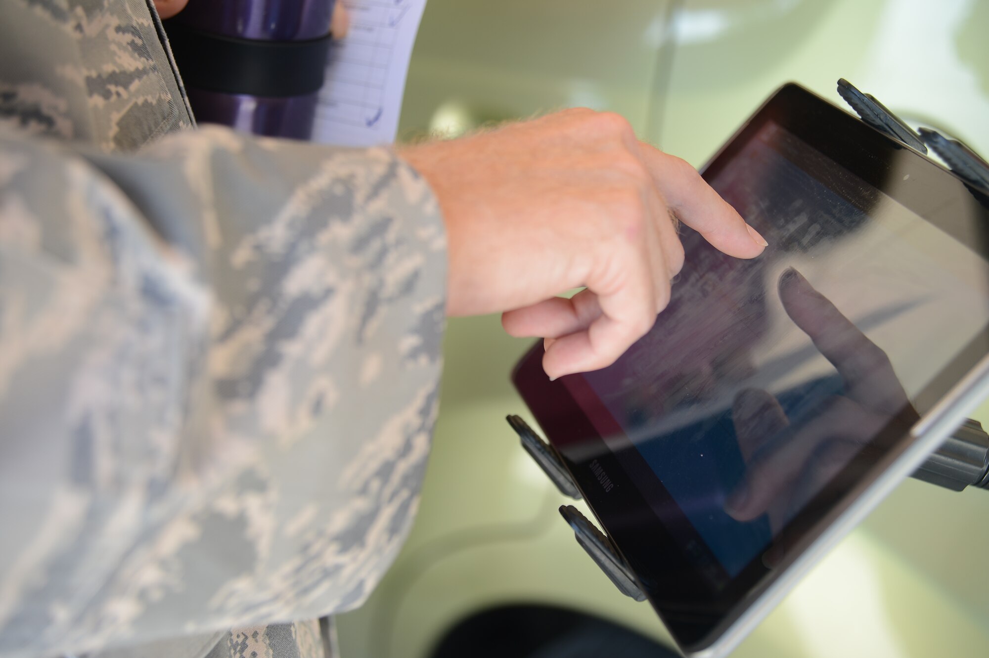 Tech Sgt. Benji Campbell, 310th Airlift Squadron flight engineer, completes a survey before participating in the Arrive Alive drunk and distracted driving simulator at MacDill Air Force Base July 23, 2013. Each participant of the simulator was given a survey before and after questioning their habits concerning distracted driving. (U.S. Air Force photo by Airman 1st Class Vernon L. Fowler Jr./Released)