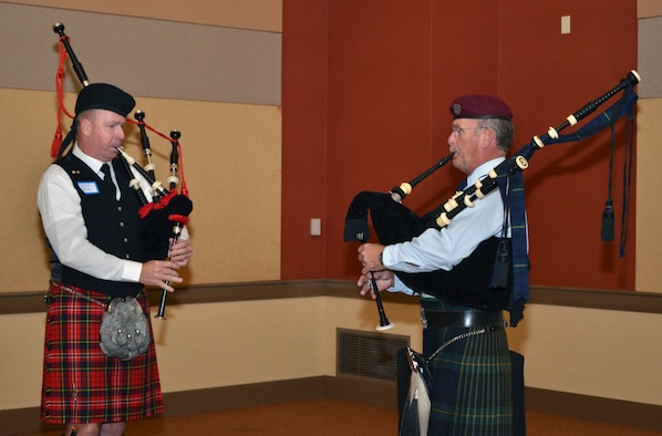 Steven Tank (left), a retired HH-60 Pave Hawk helicopter pilot, and John Pierson, a retired pararescueman, play “Amazing Grace” on their bagpipes at the beginning of the 304th Rescue Squadron reunion dinner in Portland, Ore., July 27, 2013. (U.S. Air Force photo/Tech. Sgt. Anna-Marie Wyant)